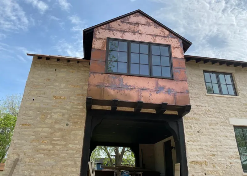 Copper metal panel facade on a stone building for Skylight Installation in Livonia
